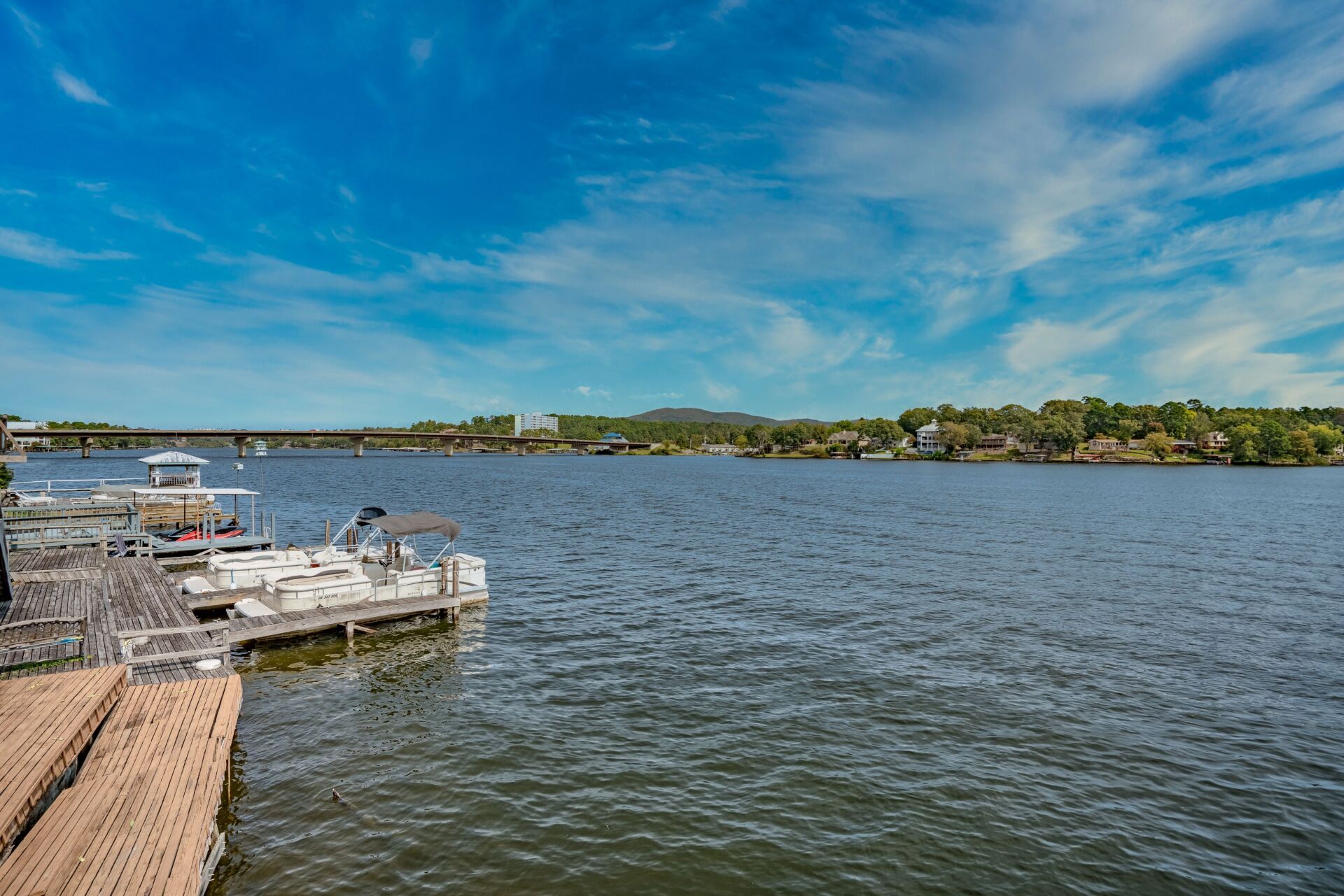 A boat is docked at a dock on a lake.