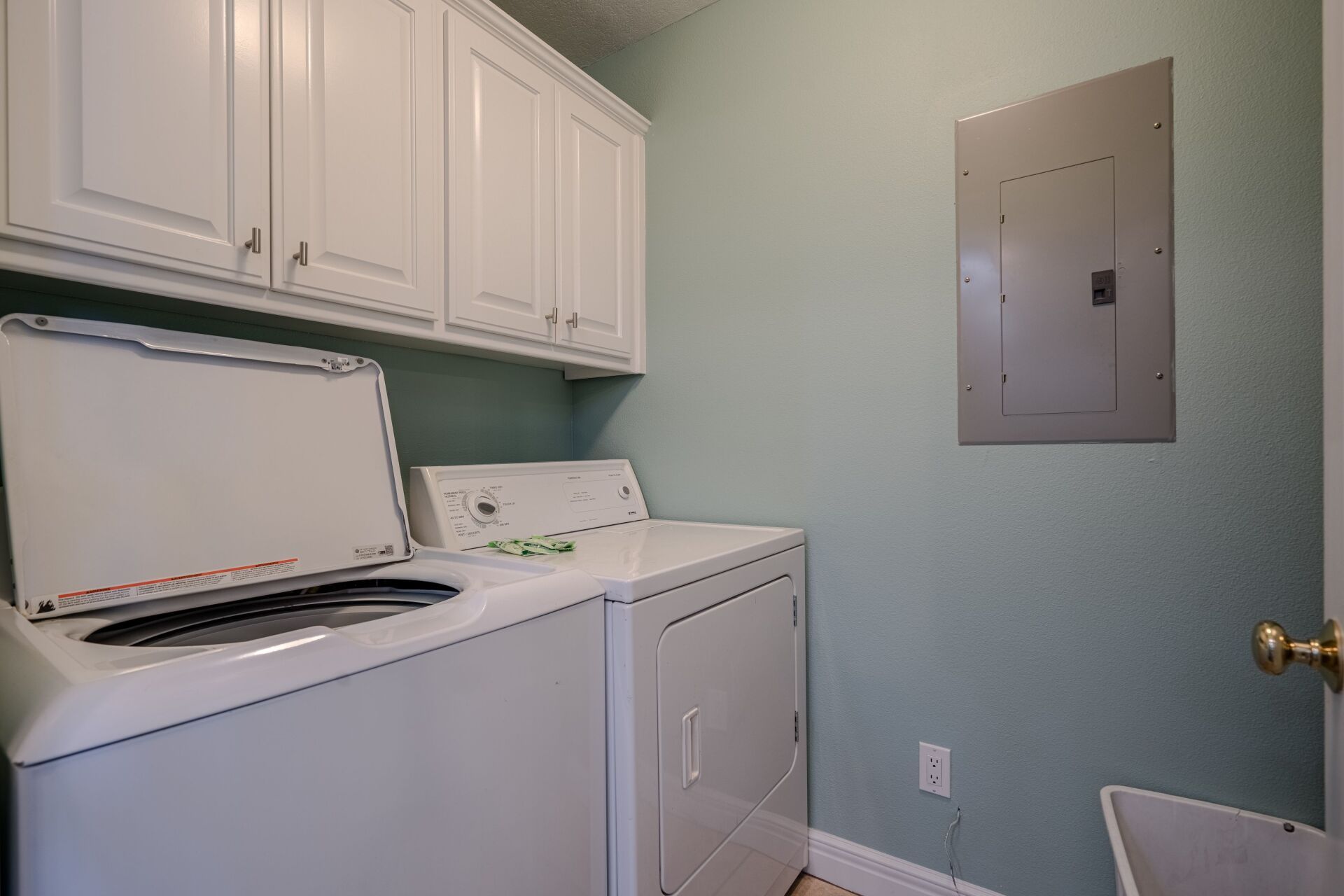 A laundry room with a washer and dryer in it.