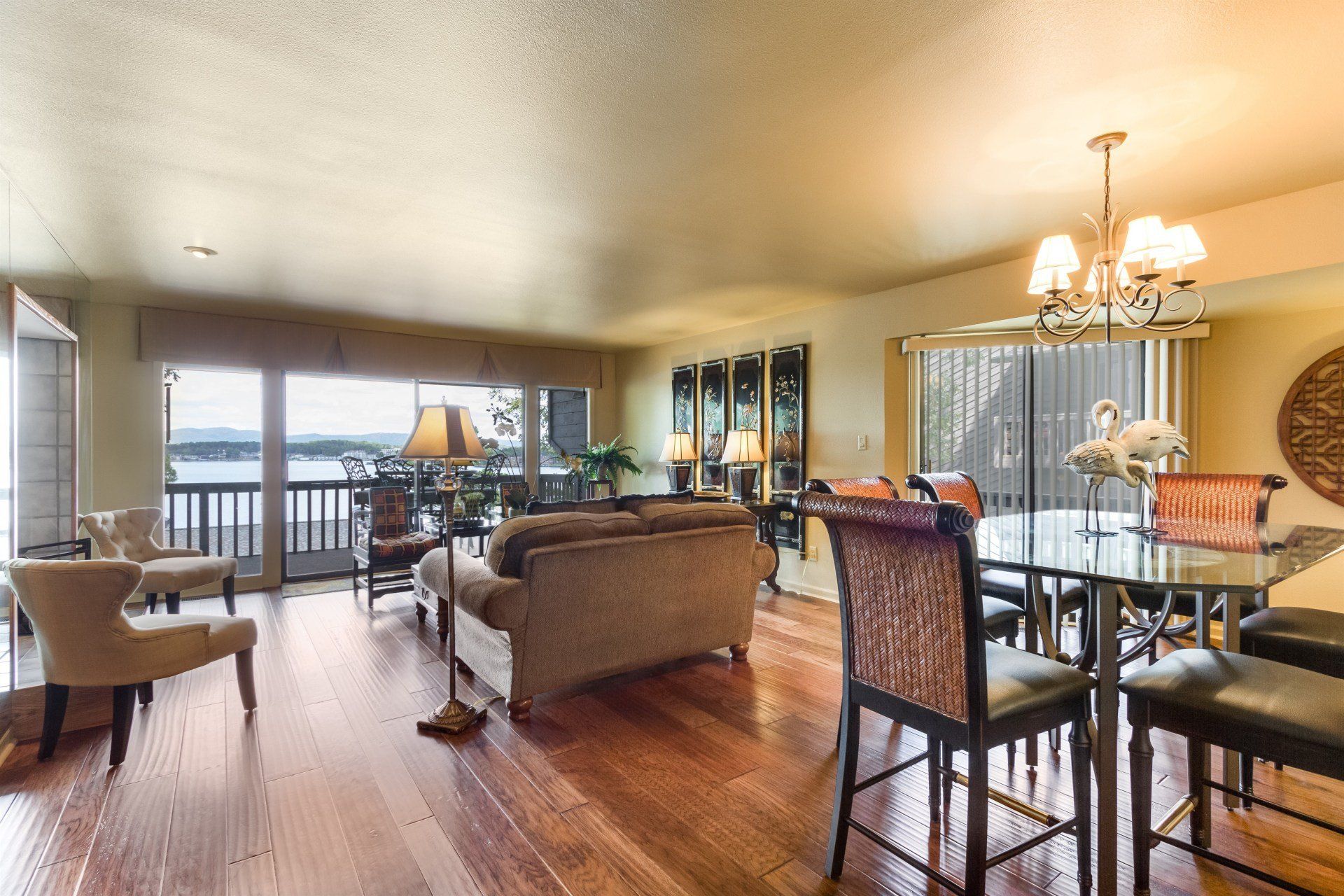 A living room with hardwood floors and a dining table