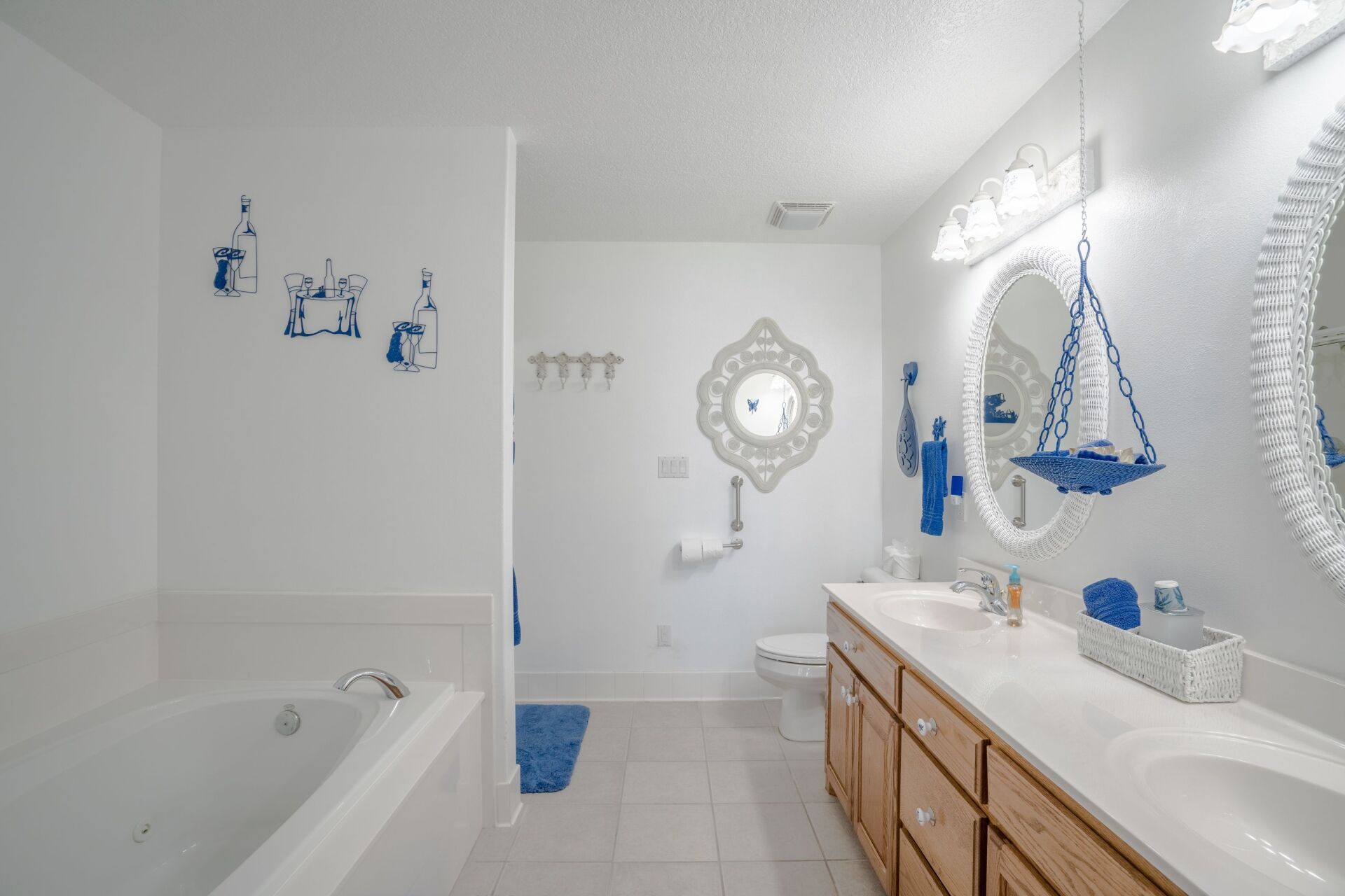 A bathroom with a tub , sink , toilet and mirror.