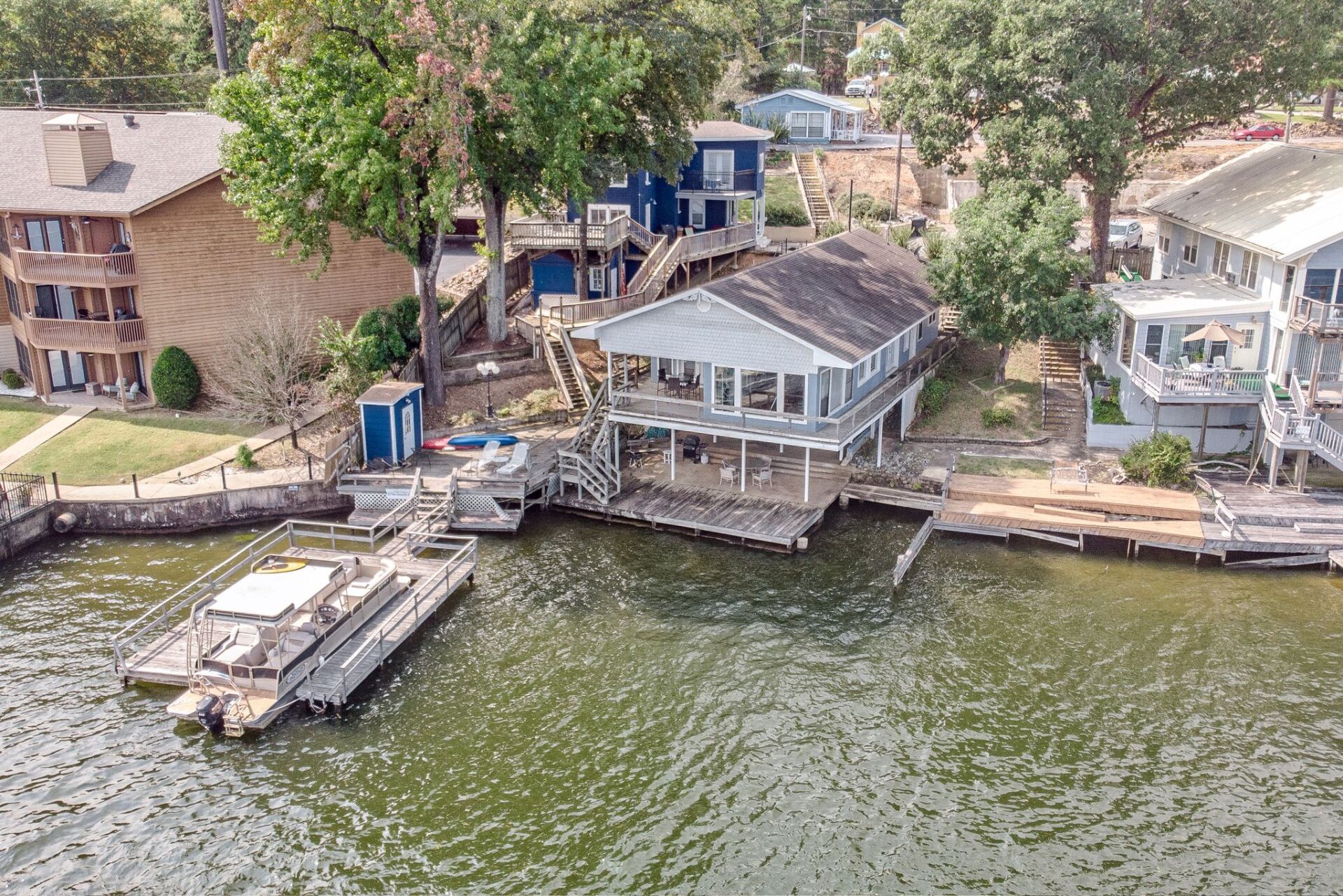 An aerial view of a house on the shore of a lake.