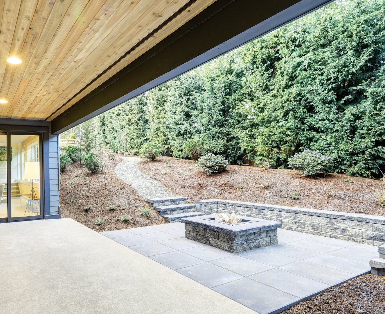 There is a fire pit on the patio of a house.