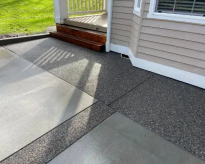 A close up of a brick pavement with a concrete border