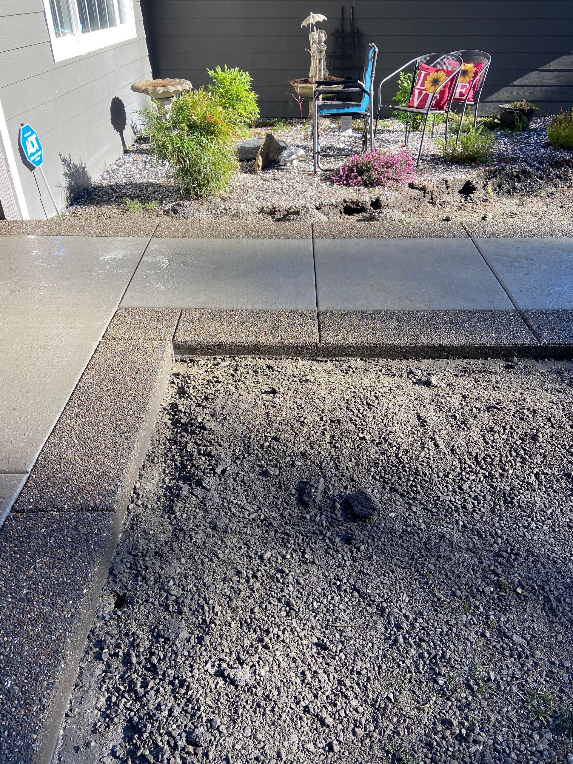 There is a butterfly statue in the middle of the gravel.