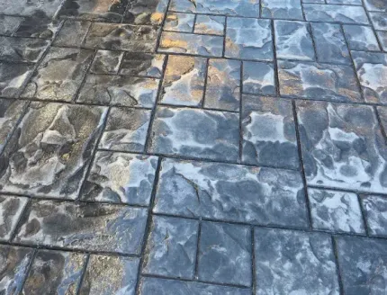 A close up of a concrete floor with a brick pattern.