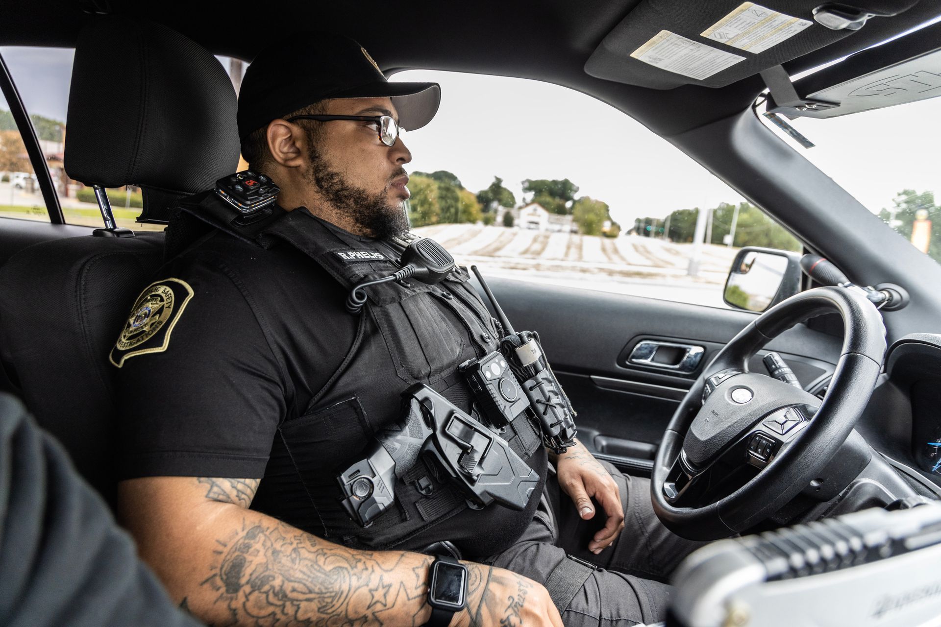 Metro Public Safety Investigations Officer sitting in driver's seat of a parked patrol vehicle