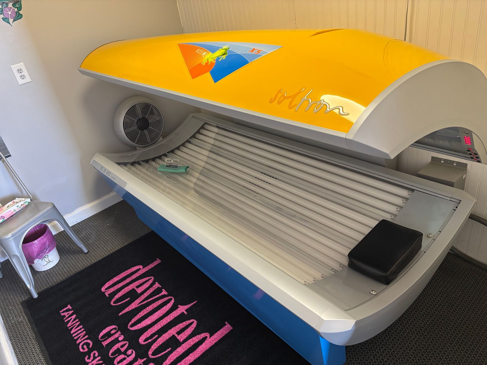 A man is pushing a large tire on the ground