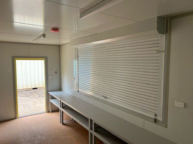 An Empty Room With a Table and a Door — Oz Shipping Containers in Teralba, NSW