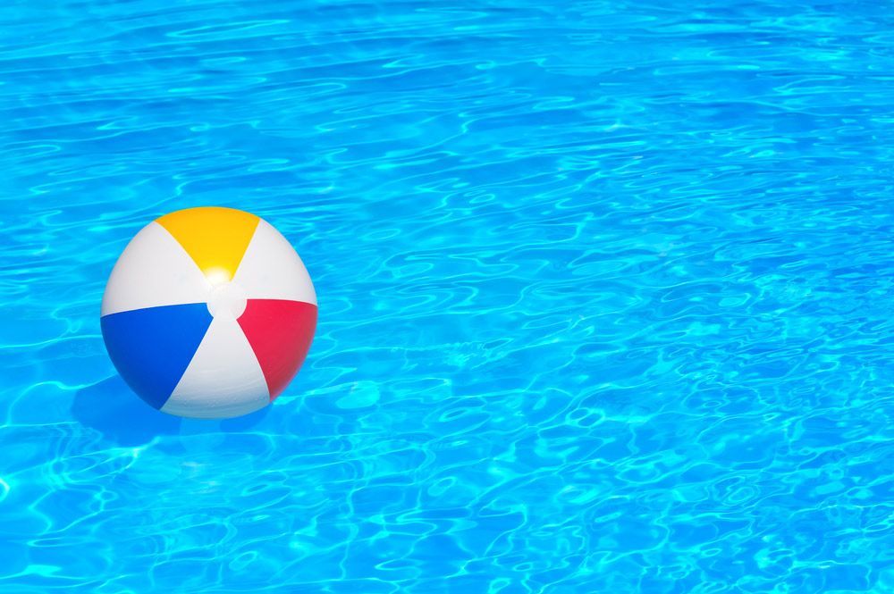 A Colorful Beach Ball is Floating in a Swimming Pool — Taree Pool Supplies in Wingham, NSW