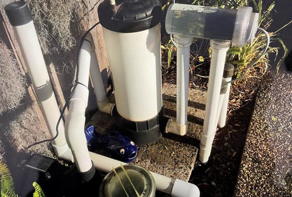 A Swimming Pool Filter is Sitting on Top of a Concrete Surface — Taree Pool Supplies in Wingham, NSW