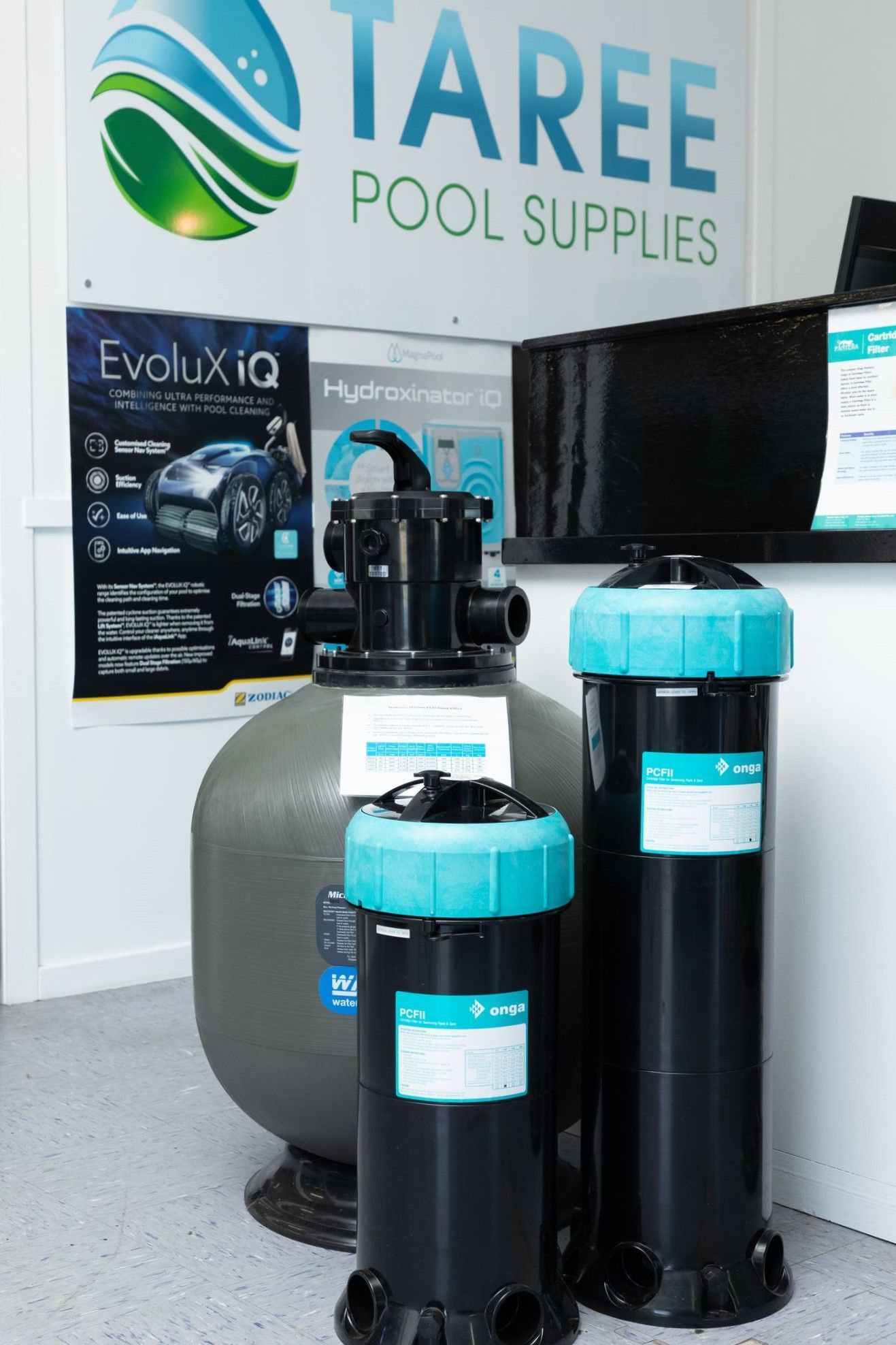 Two Black Cylinders Are in Front of a Sign That Says ' Taree Pool Supplies ' on It — Taree Pool Supplies in Taree, NSW