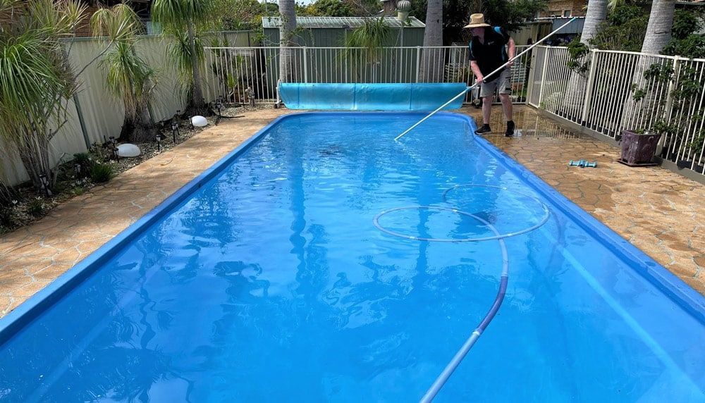 Man Brushing a Pool — Taree Pool Supplies in Taree, NSW