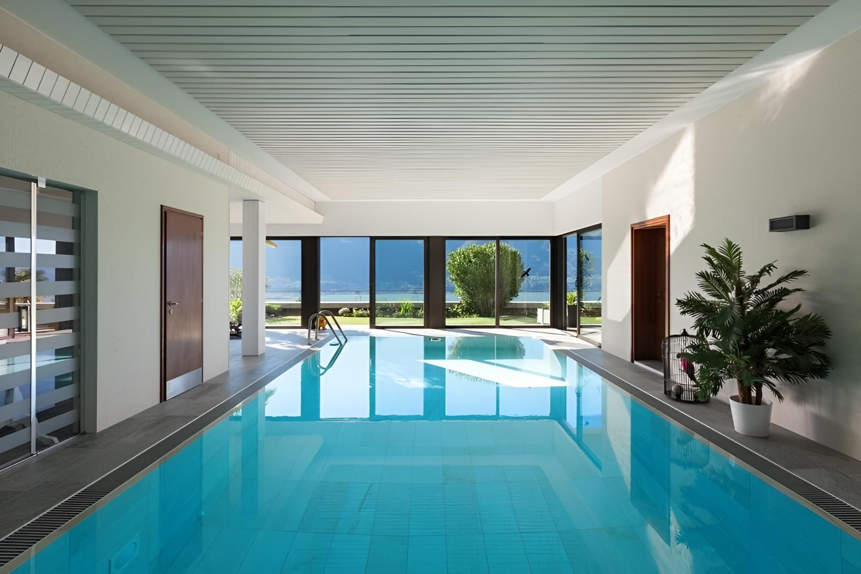 A Large Indoor Swimming Pool With a Lot of Windows — Taree Pool Supplies in Taree, NSW