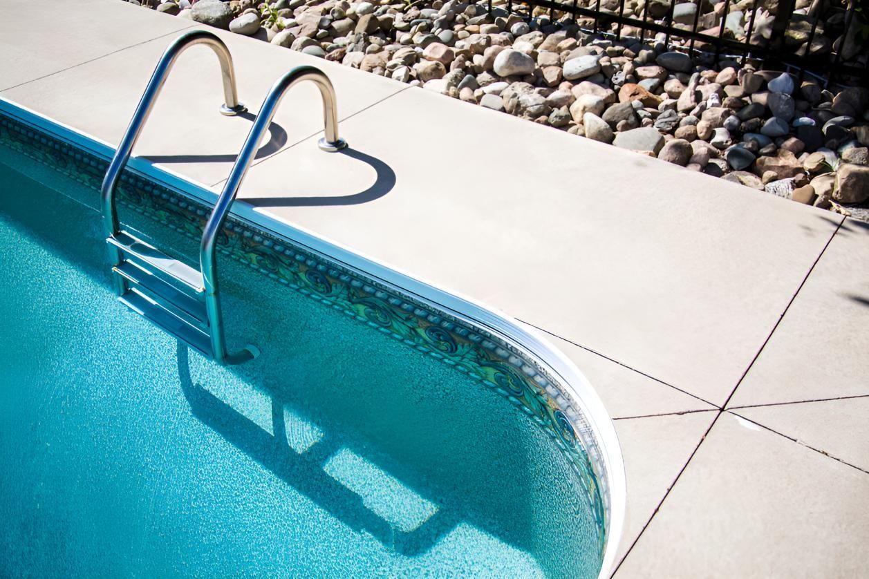 A Swimming Pool With a Heart Shaped Ladder in the Water — Taree Pool Supplies in Harrington, NSW