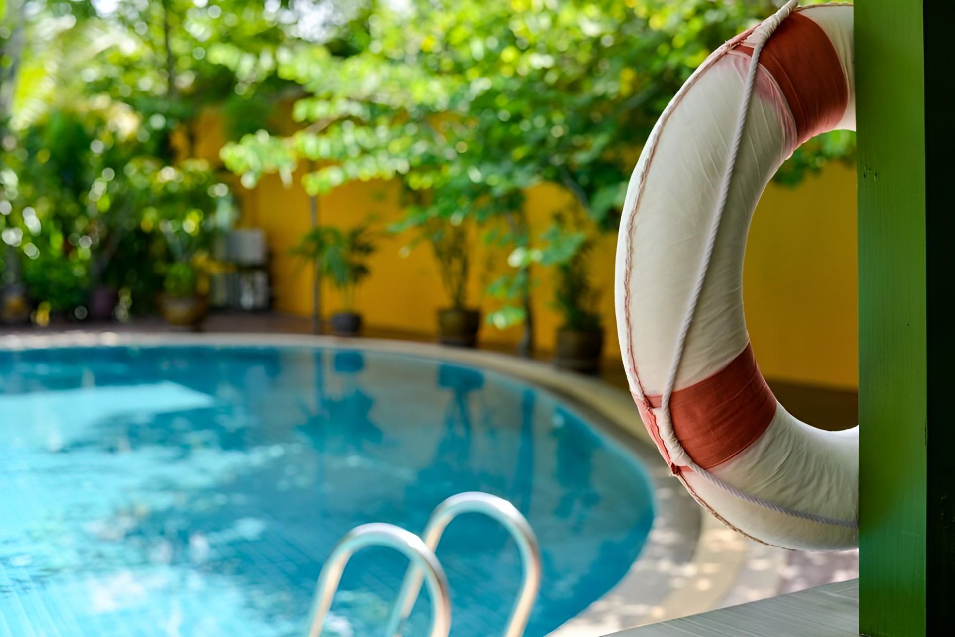 A Life Preserver is Hanging Over a Swimming Pool — Taree Pool Supplies in Forster, NSW