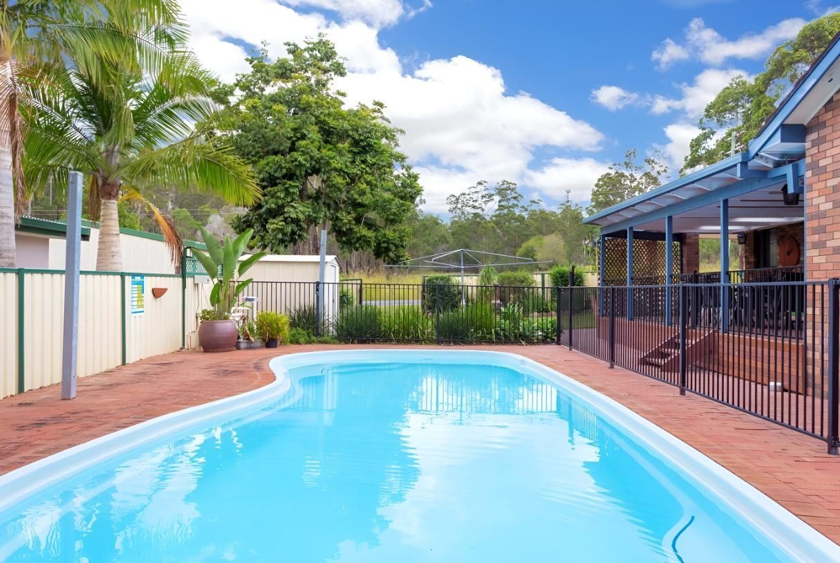 A Large Swimming Pool in the Backyard of a House — Taree Pool Supplies in Wingham, NSW