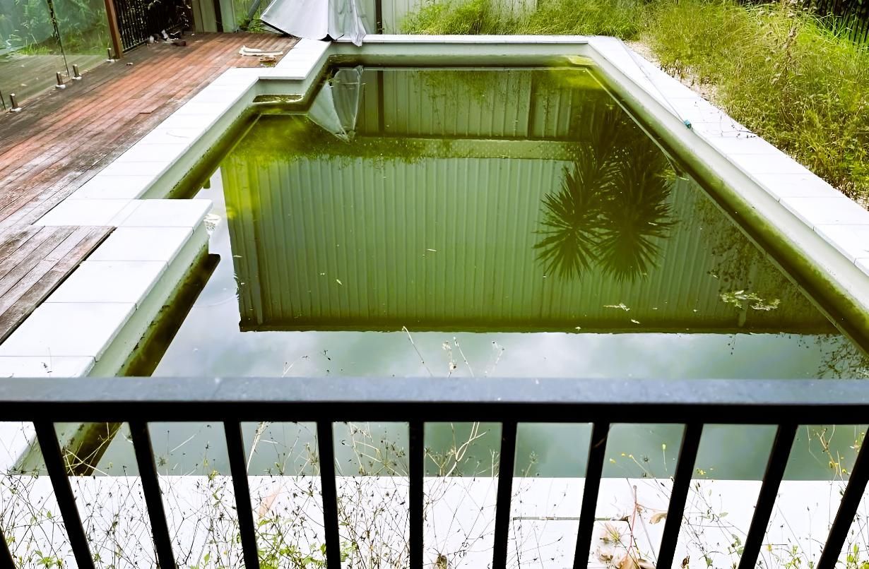 A Large Swimming Pool With a Fence Around It — Taree Pool Supplies in Forster, NSW