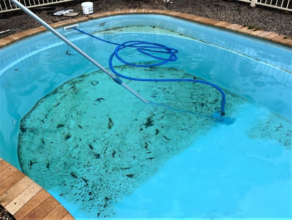 A Dirty Swimming Pool With a Hose Attached to It — Taree Pool Supplies in Forster, NSW