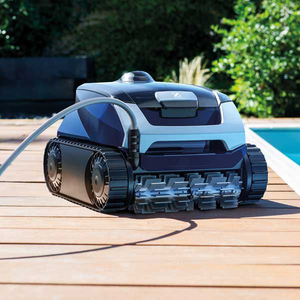 A Robotic Pool Cleaner is Sitting on a Wooden Deck Next to a Pool — Taree Pool Supplies in Harrington, NSW
