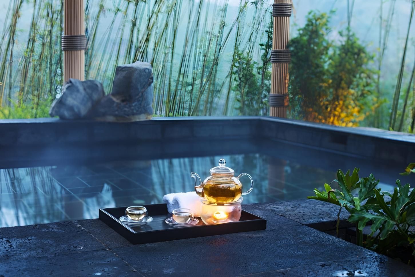 A Teapot is Sitting on a Tray in Front of a Hot Tub — Taree Pool Supplies in Forster, NSW