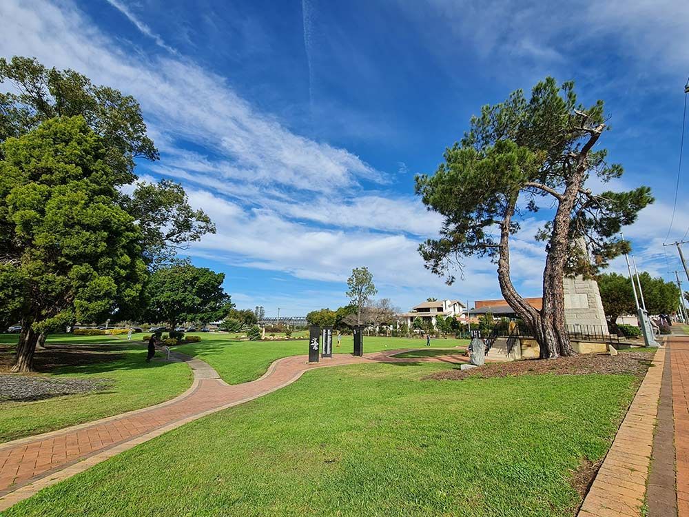 A Park With a Brick Walkway and Trees on a Sunny Day — Taree Pool Supplies in Taree, NSW