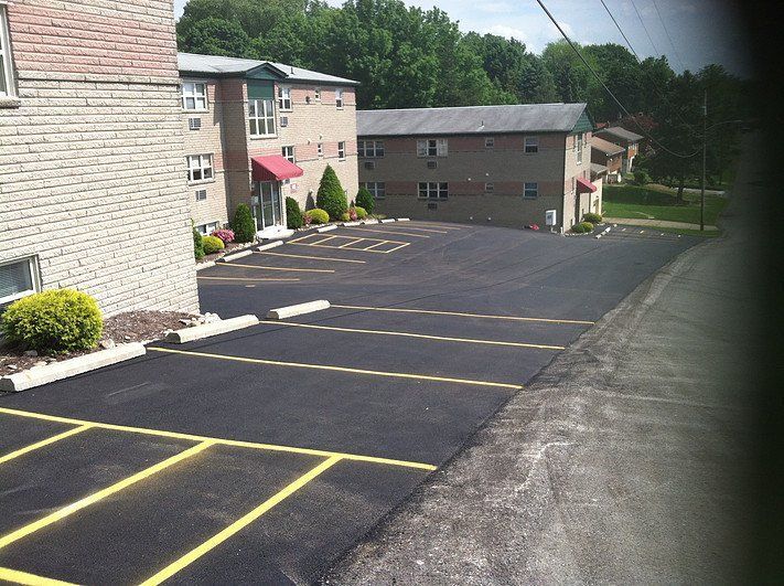 A parking lot with a brick building in the background
