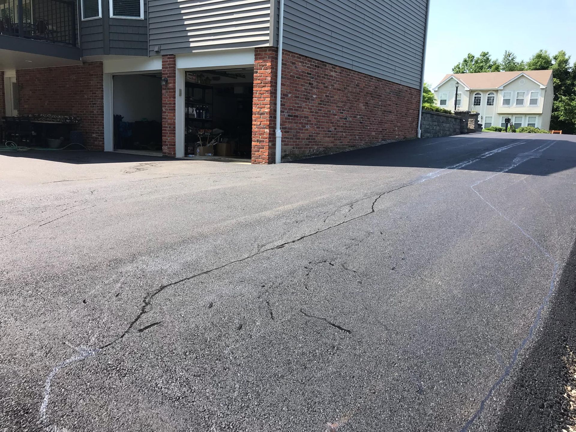 A driveway with a brick building in the background