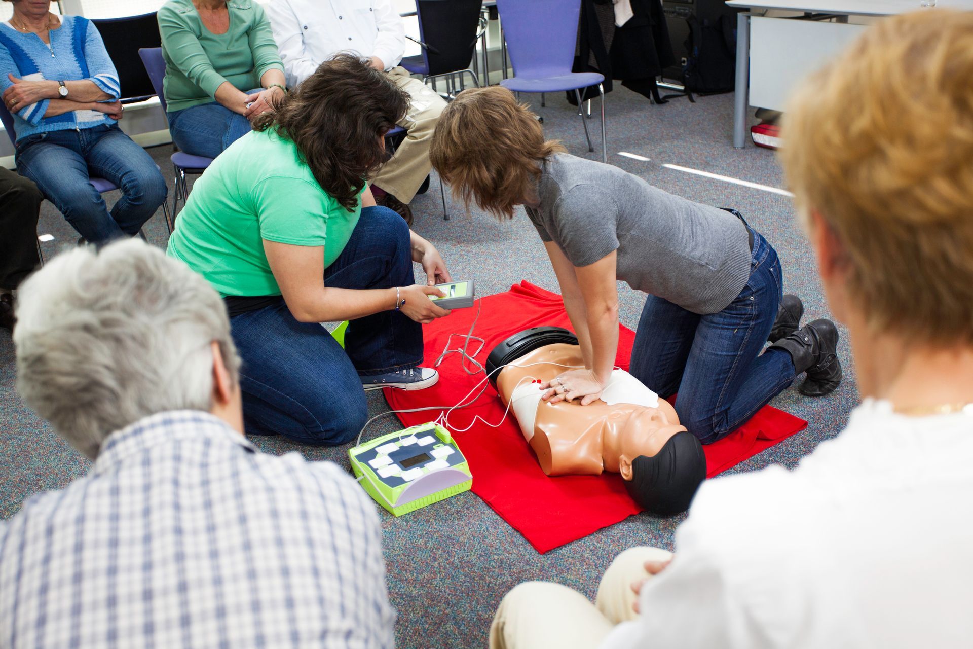 Female instructors demonstrating chest compression