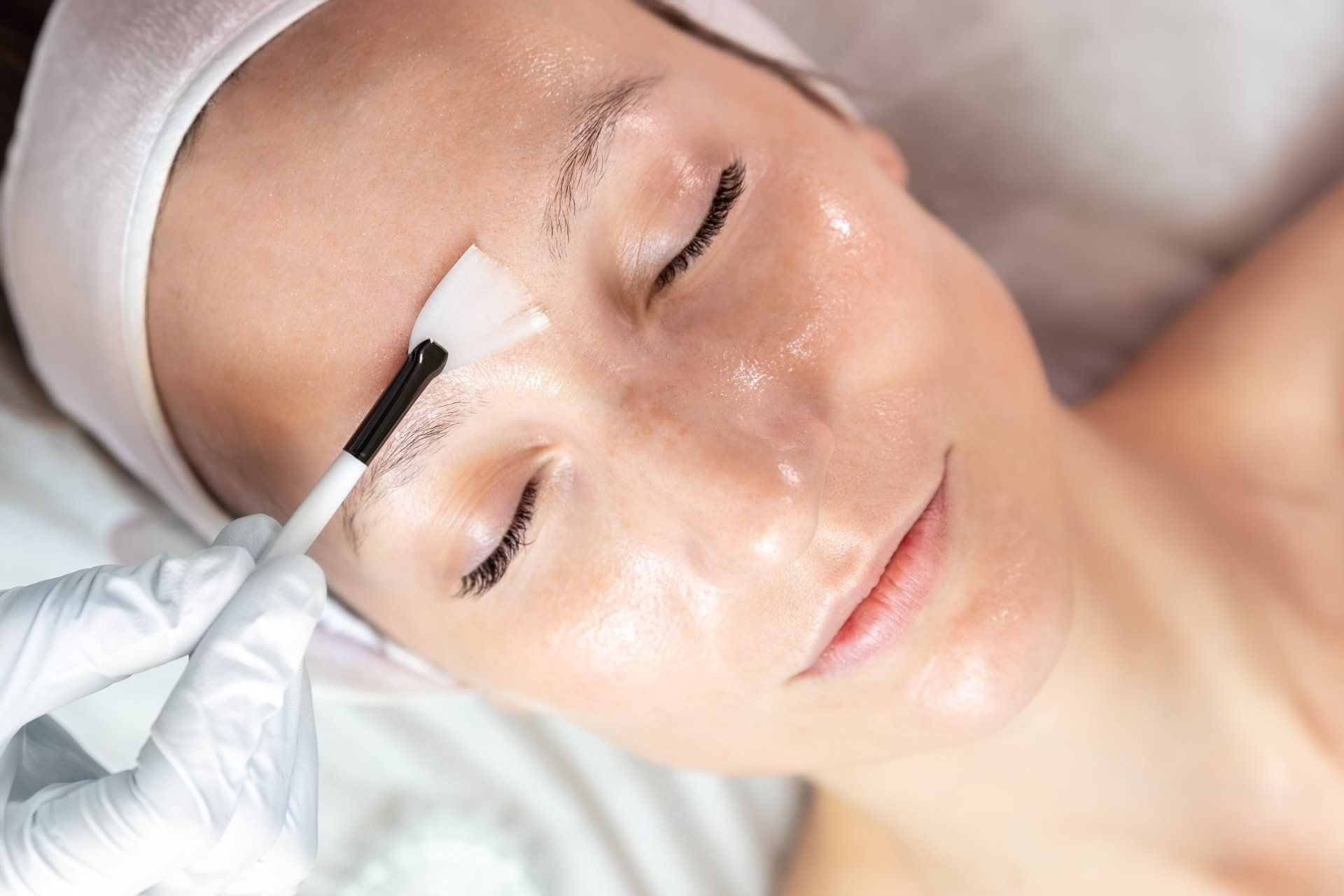 A woman is getting her eyebrows waxed at a beauty salon.