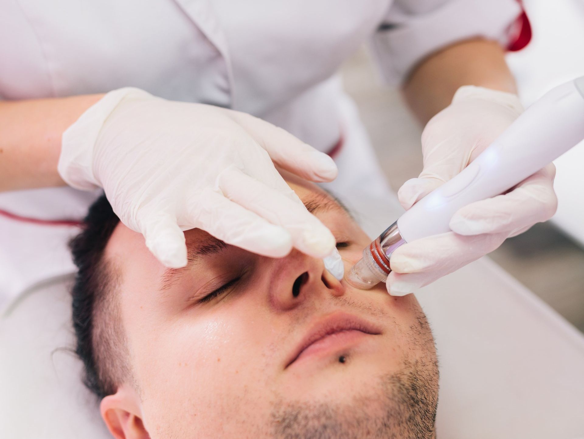 A man is getting a facial treatment at a beauty salon.