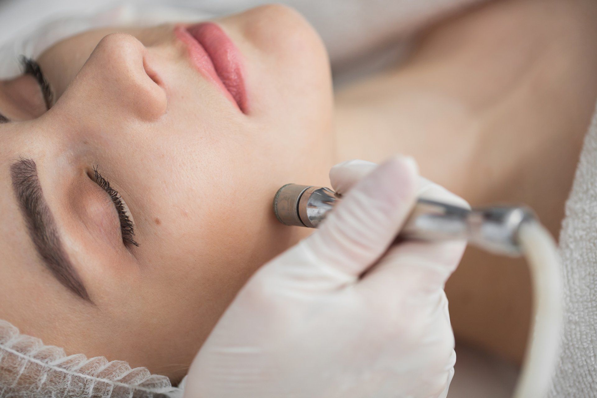 A woman is getting a facial treatment at a beauty salon.