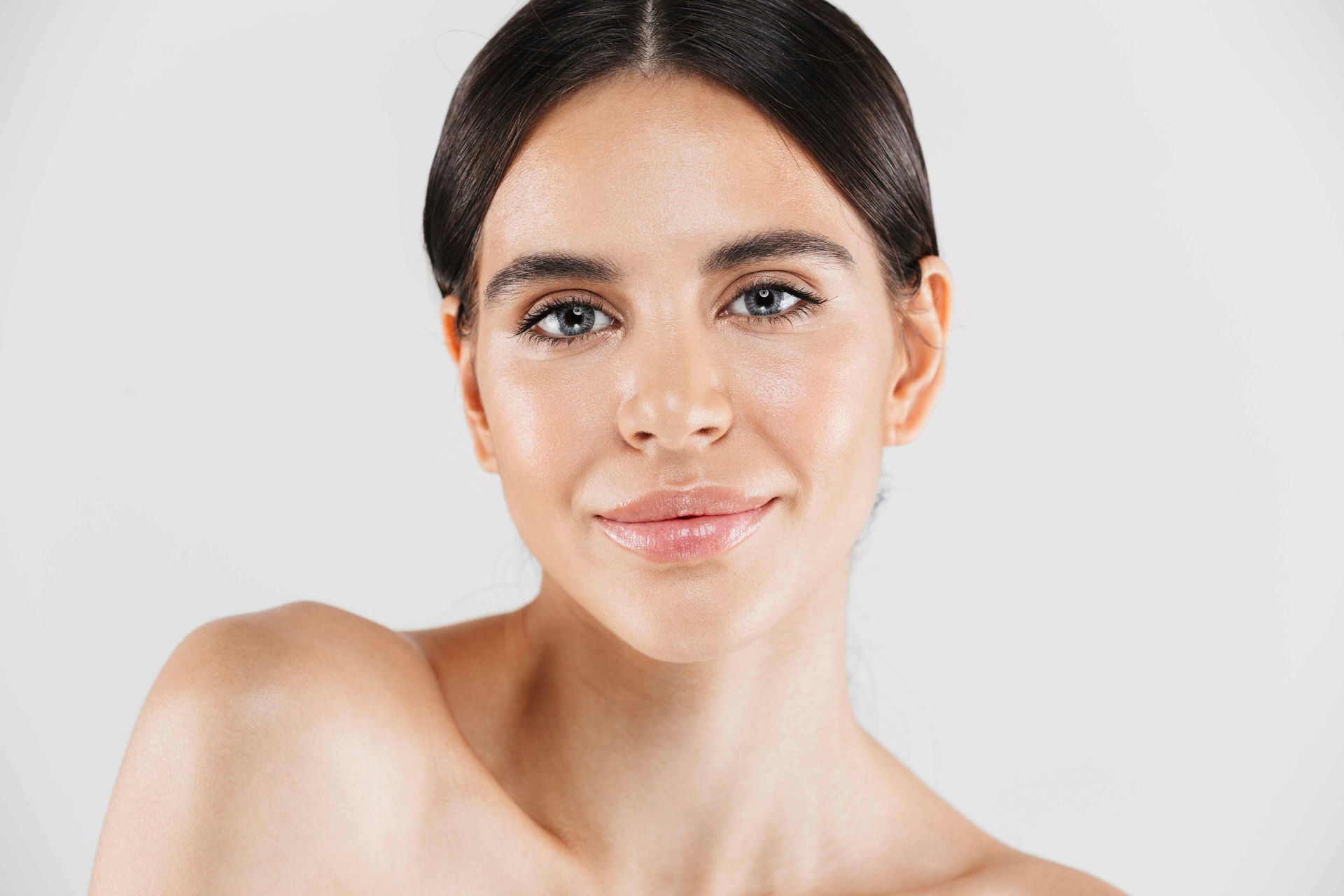 A close up of a woman 's face with a white background.