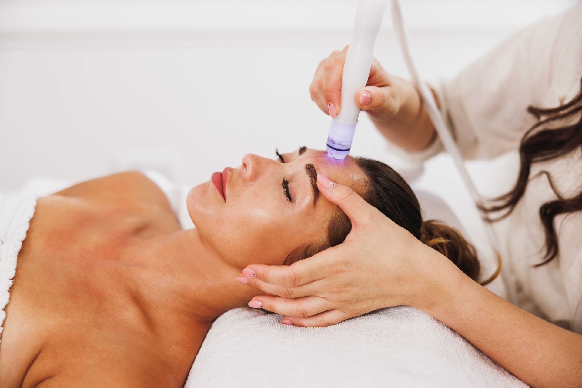 A woman is getting a facial treatment at a spa.