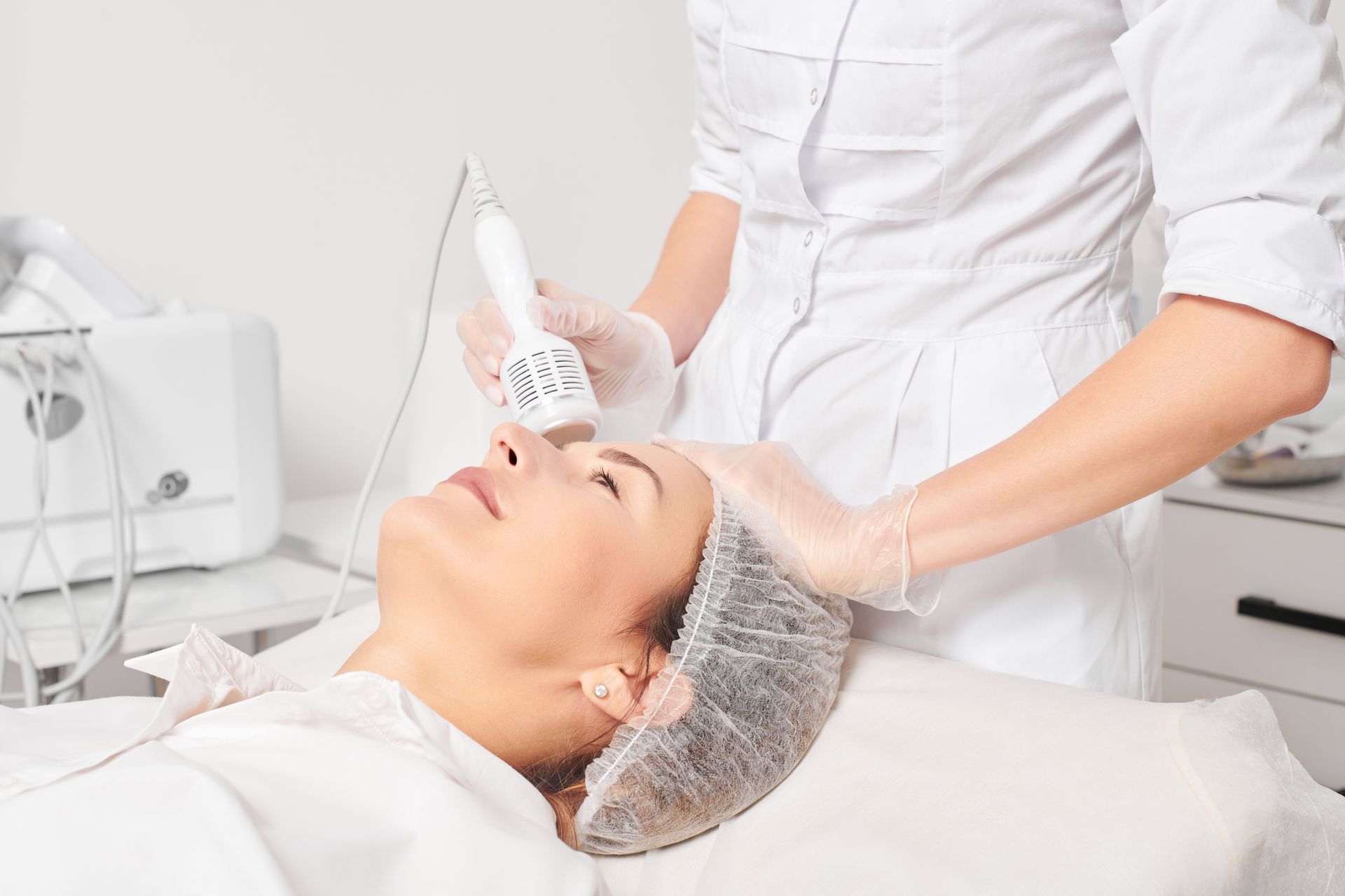 A woman is getting a facial treatment at a beauty salon.