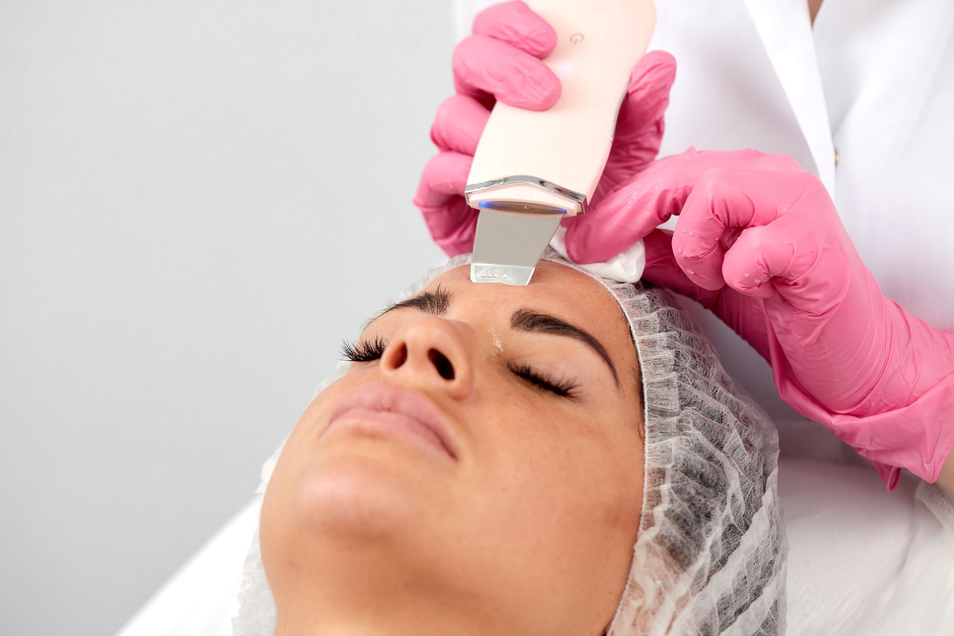 A woman is getting a facial treatment at a beauty salon.