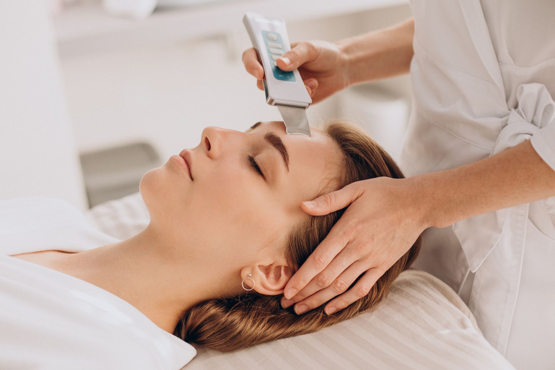 A woman is getting a facial treatment at a beauty salon.