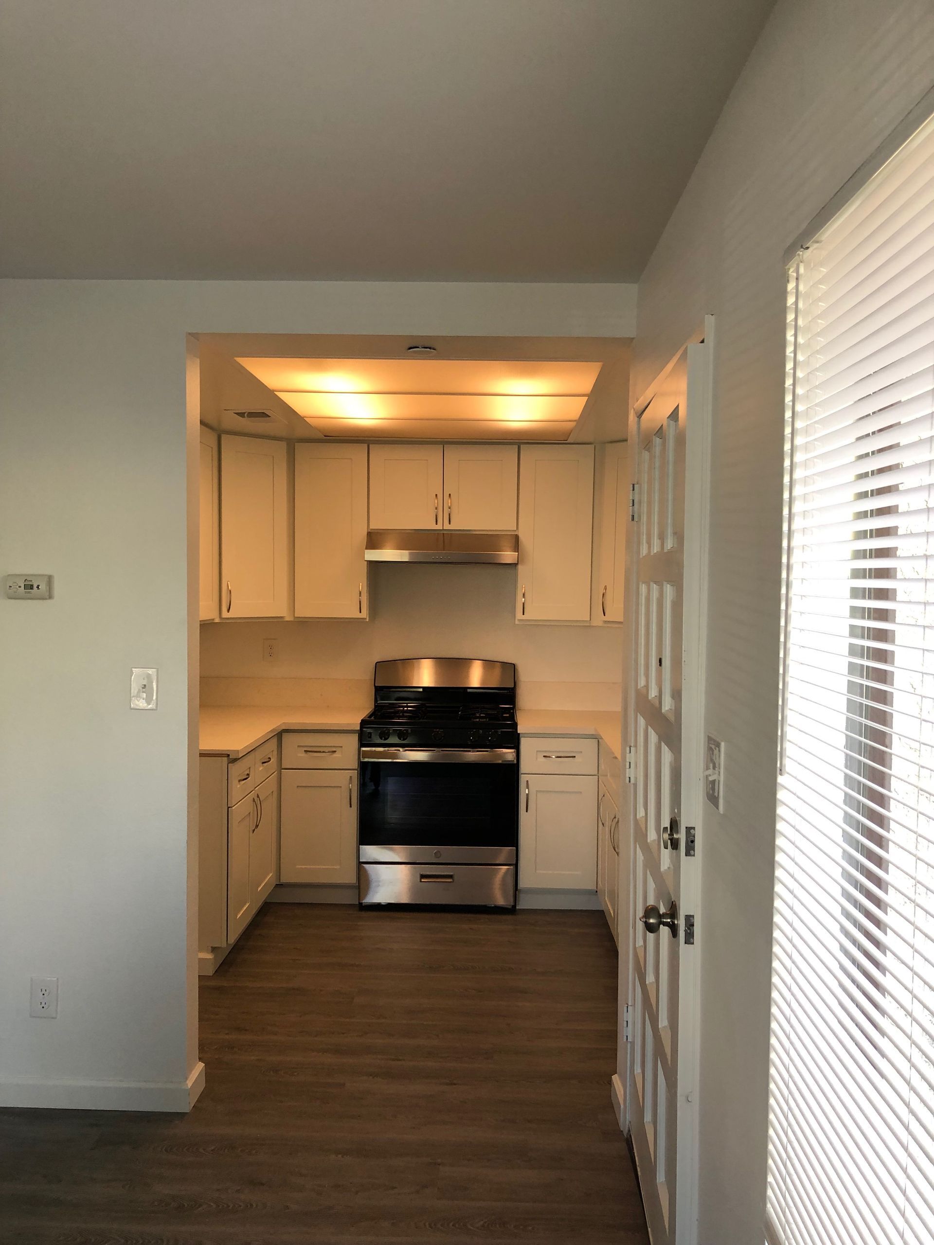 a kitchen with stainless steel appliances and white cabinets