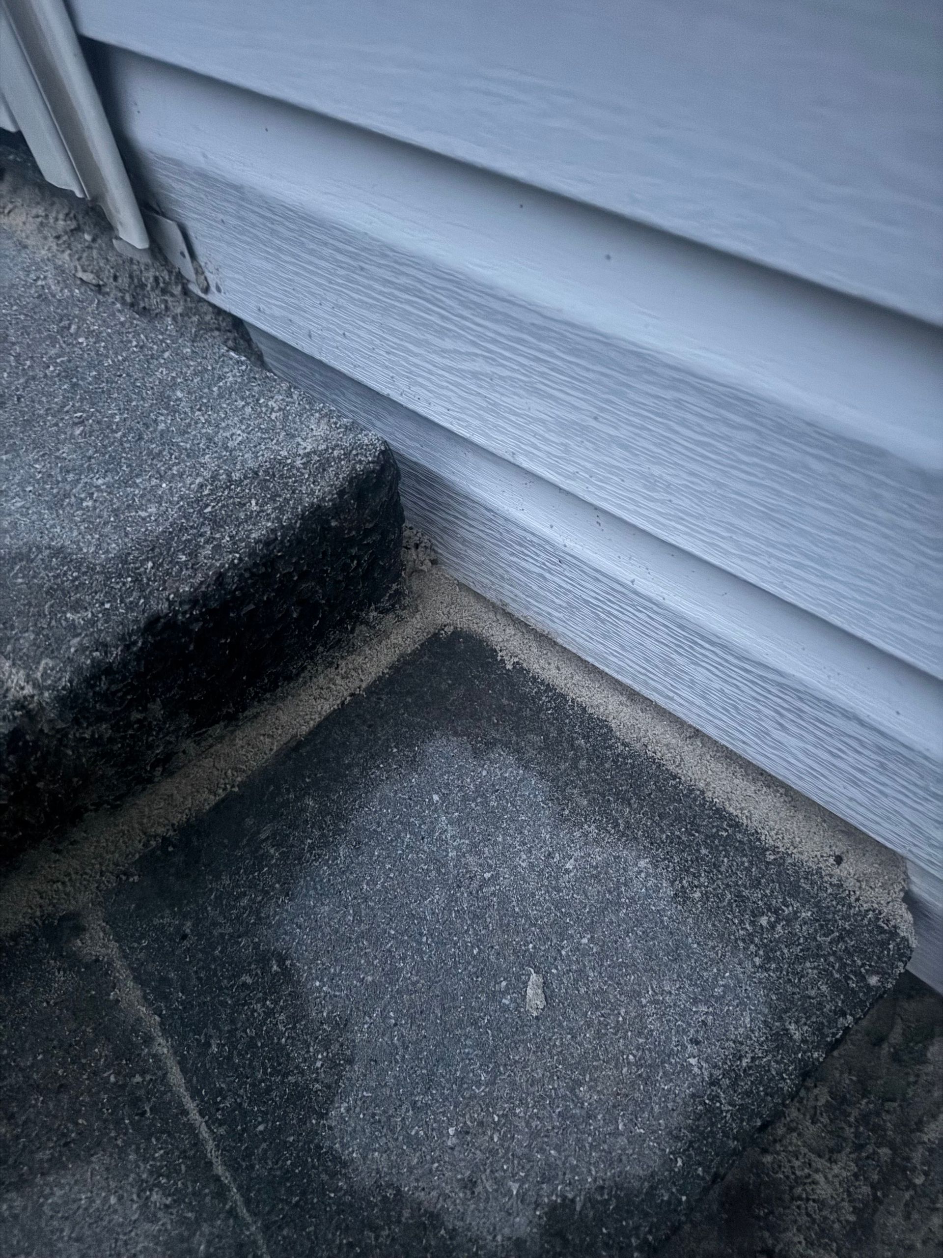 Gray siding meets gray stone pavers.