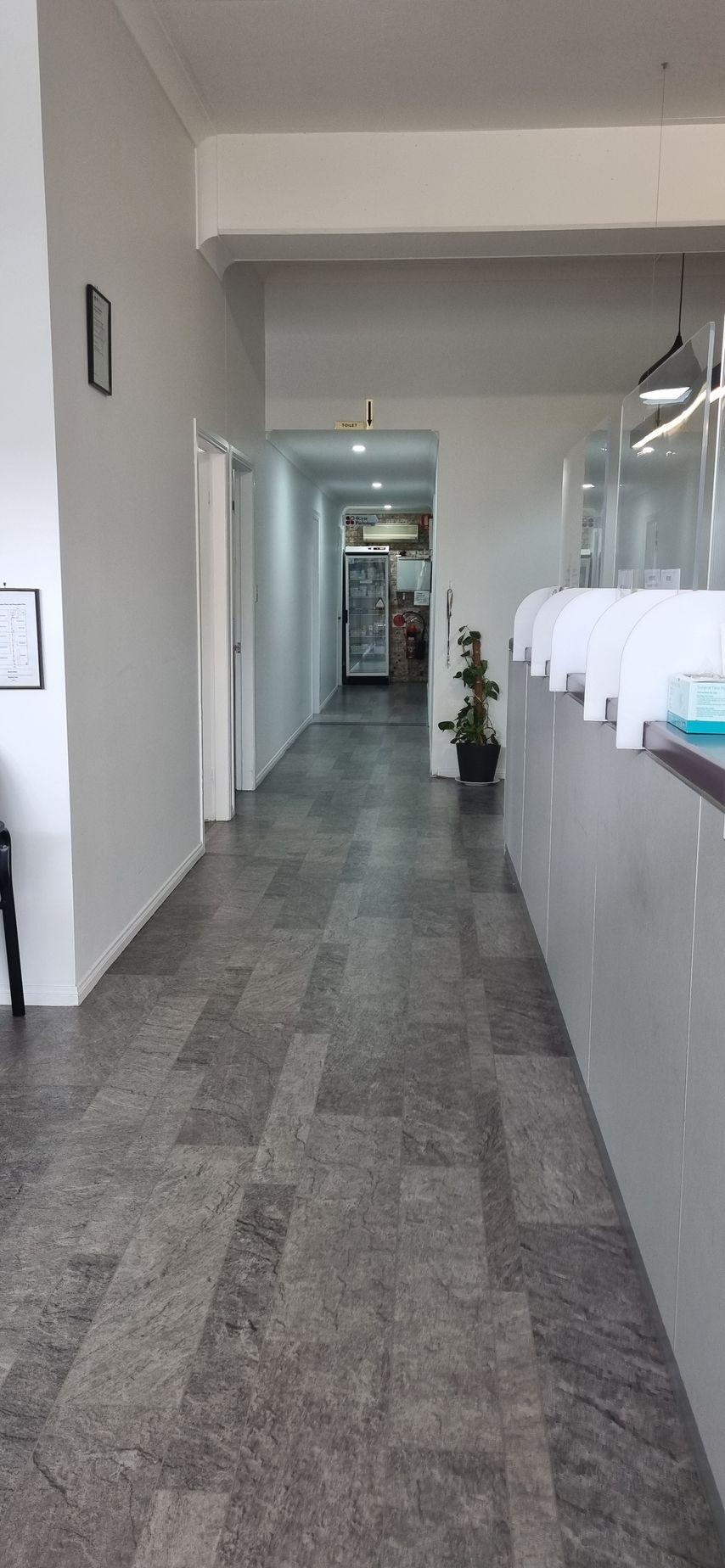 A Waiting Room with A Table and Chairs and A Vase of Flowers — Tuncurry Medical Centre In Tuncurry, NSW