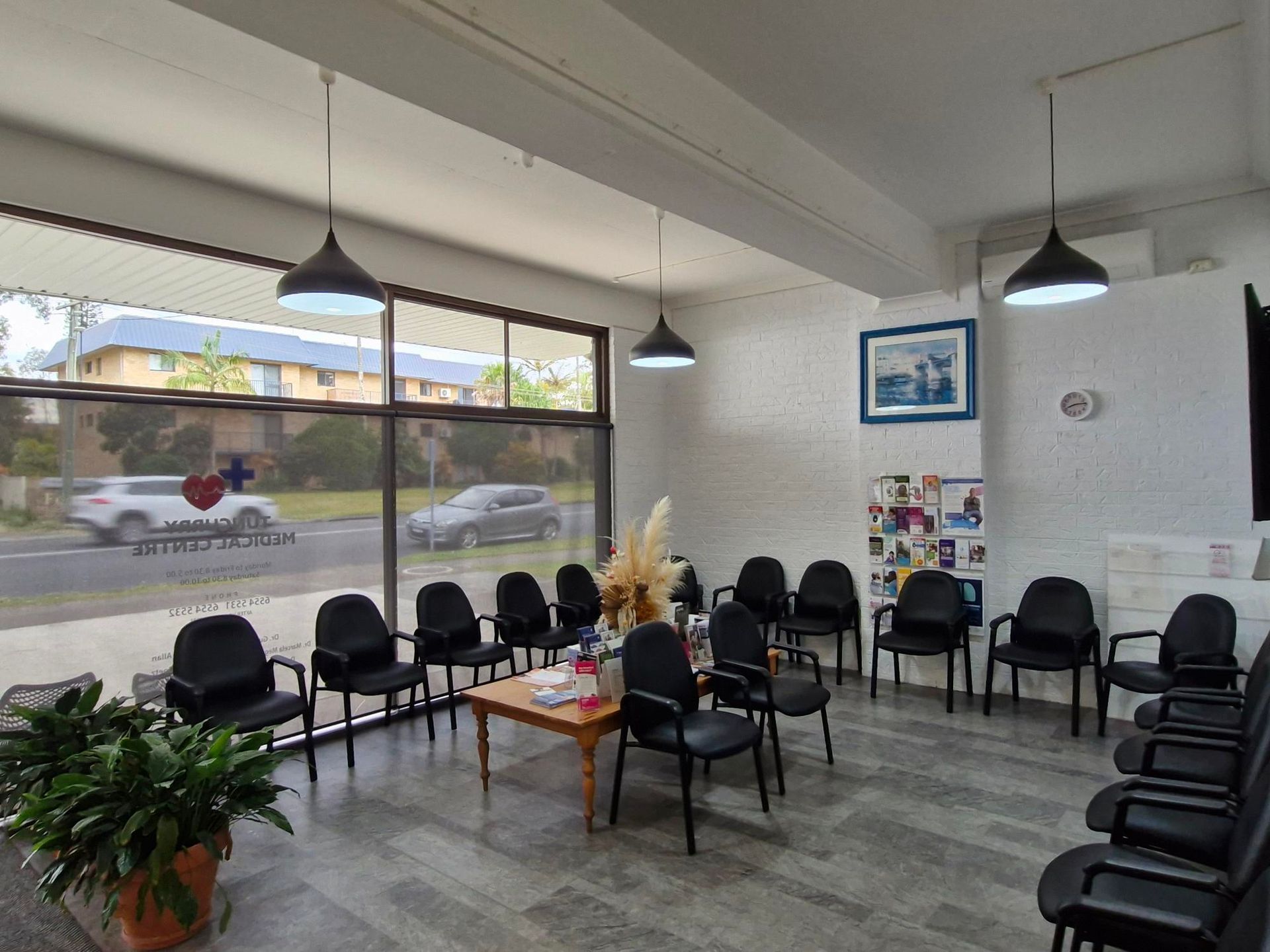A Doctor Is Talking to A Patient While Holding a Clipboard — Tuncurry Medical Centre In Tuncurry, NSW