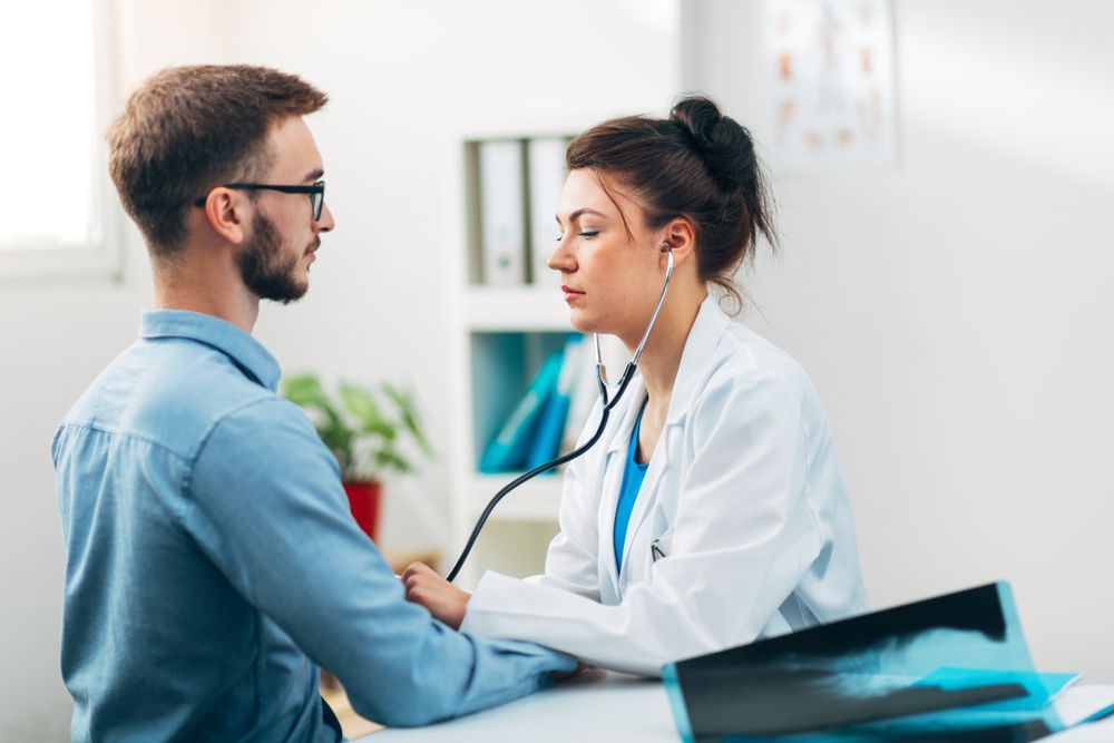 A Doctor Is Listening to A Patient 's Heartbeat with A Stethoscope — Tuncurry Medical Centre In Tuncurry, NSW