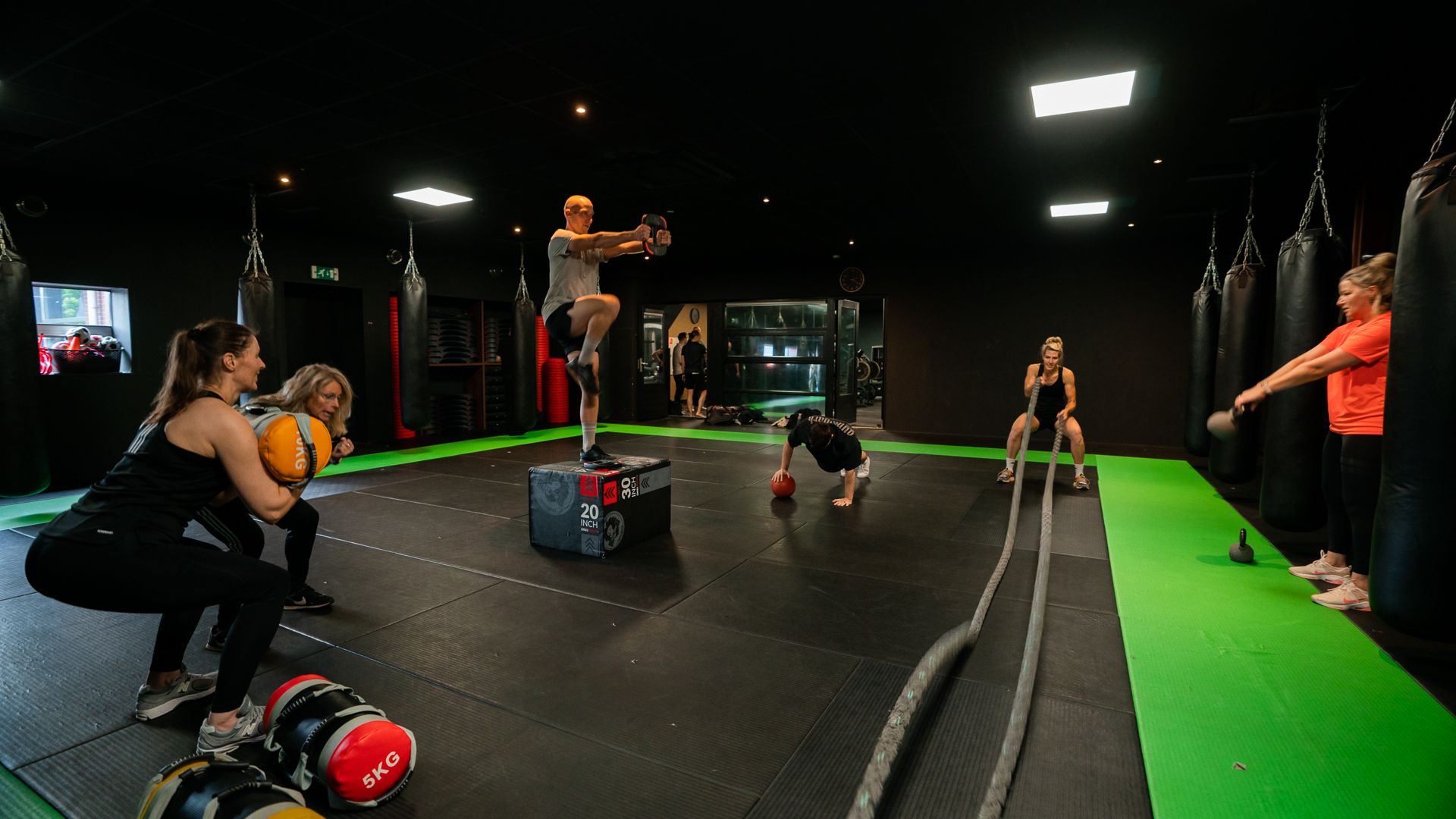 Een groep mensen doet oefeningen in een sportschool.