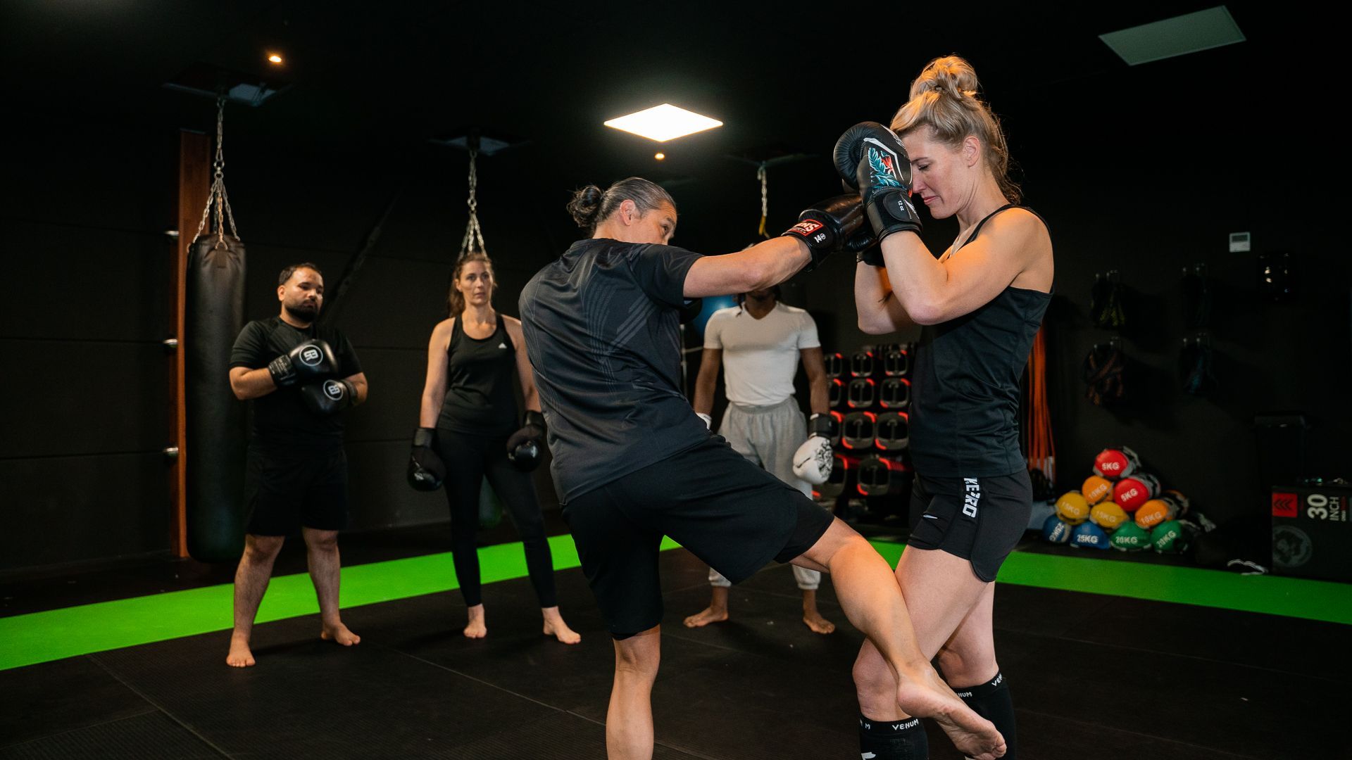 Een groep mensen beoefent vechtsporten in een sportschool.
