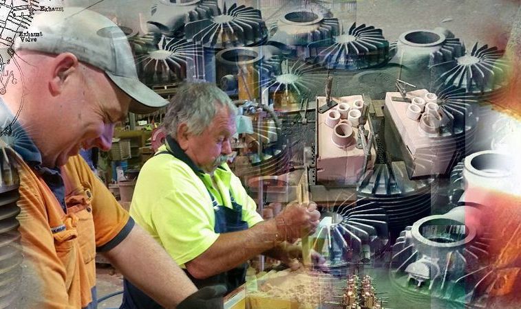 Two men are working on a machine in a factory.