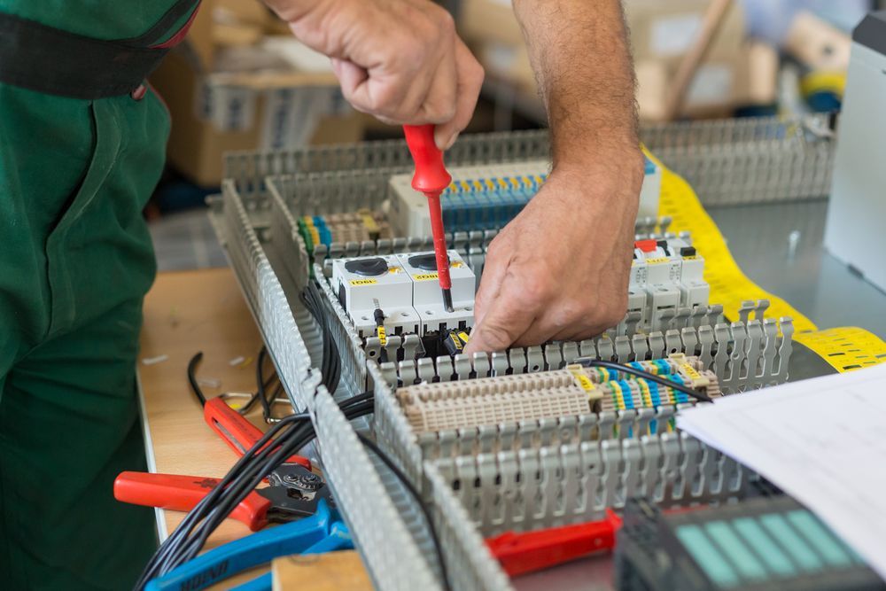 engineer working on an electrical control panel assembly