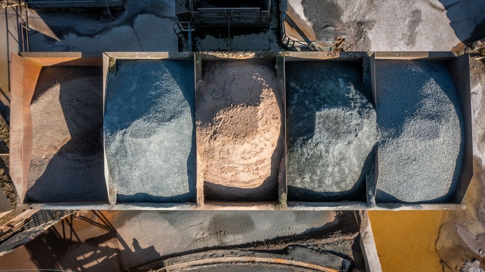 Overhead view of five bins filled with different colored gravel.
