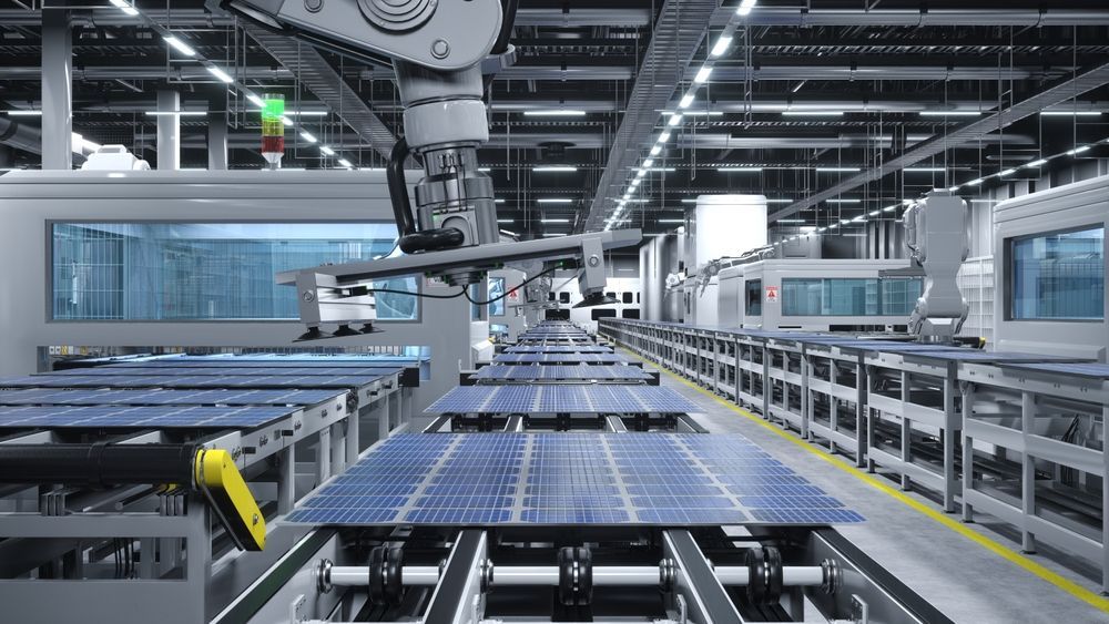 Robotic arms assembling solar panels on a factory production line.