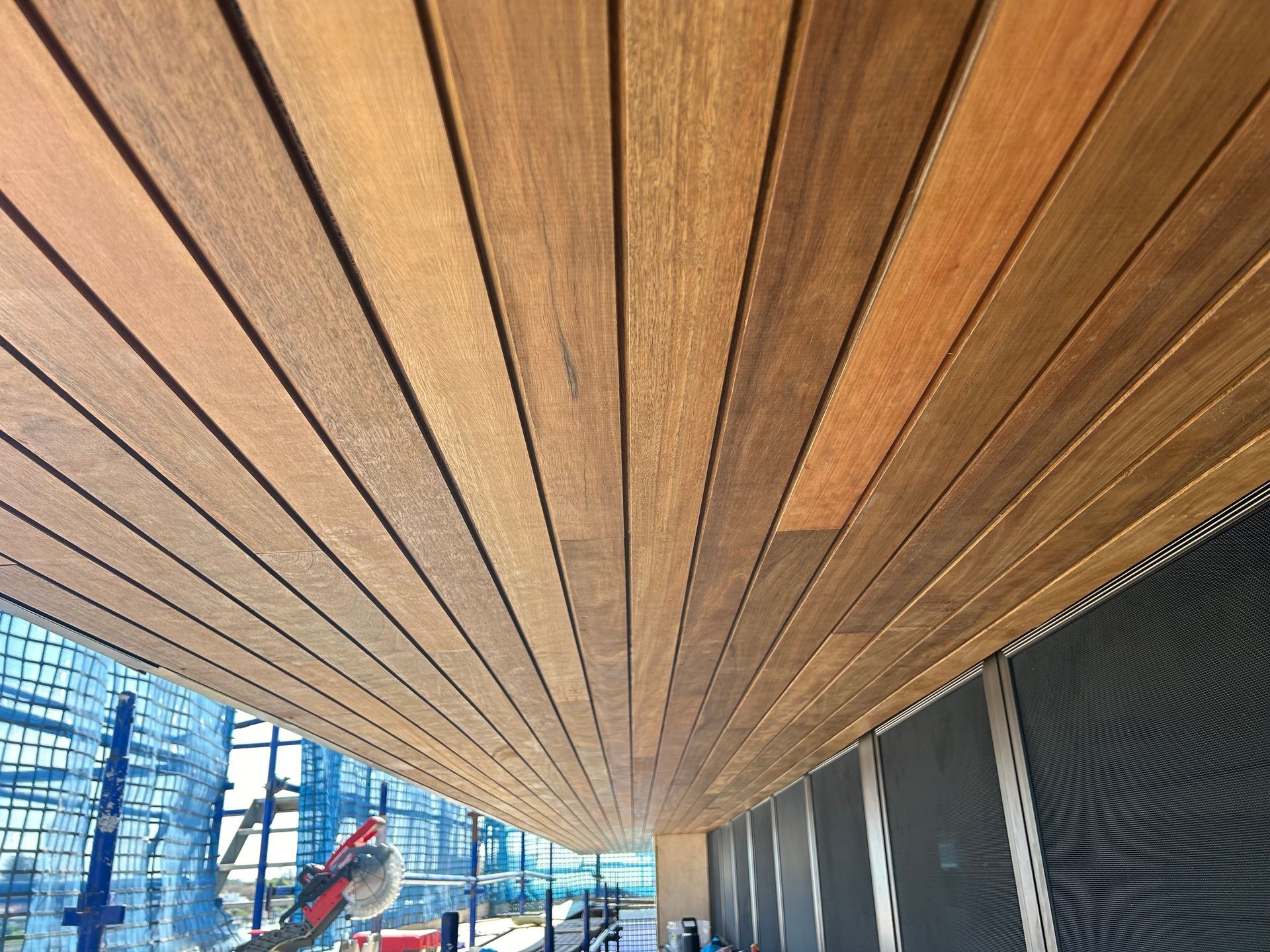 Looking up at a wooden ceiling in a building under construction.