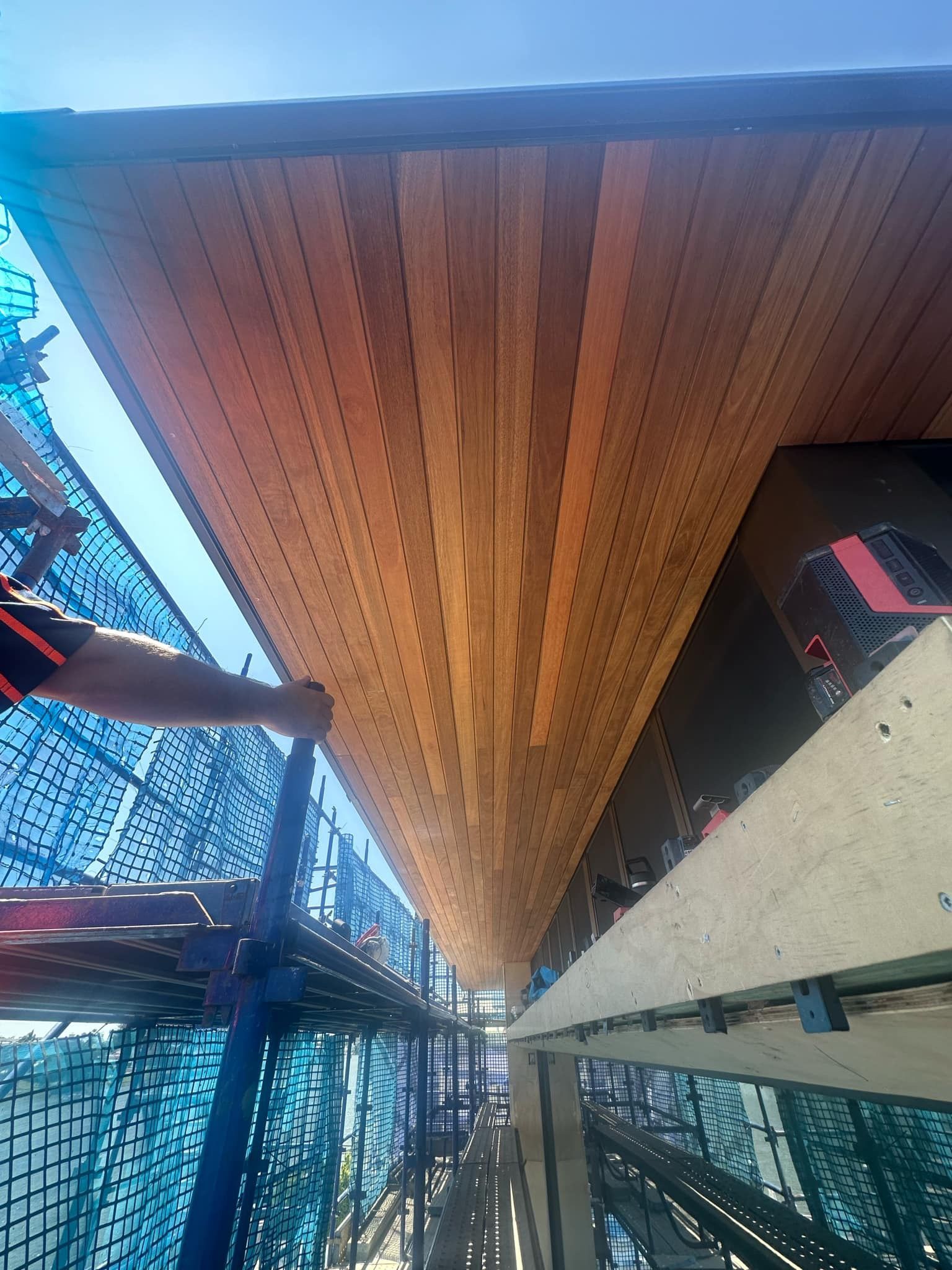 A man is working on the ceiling of a building.