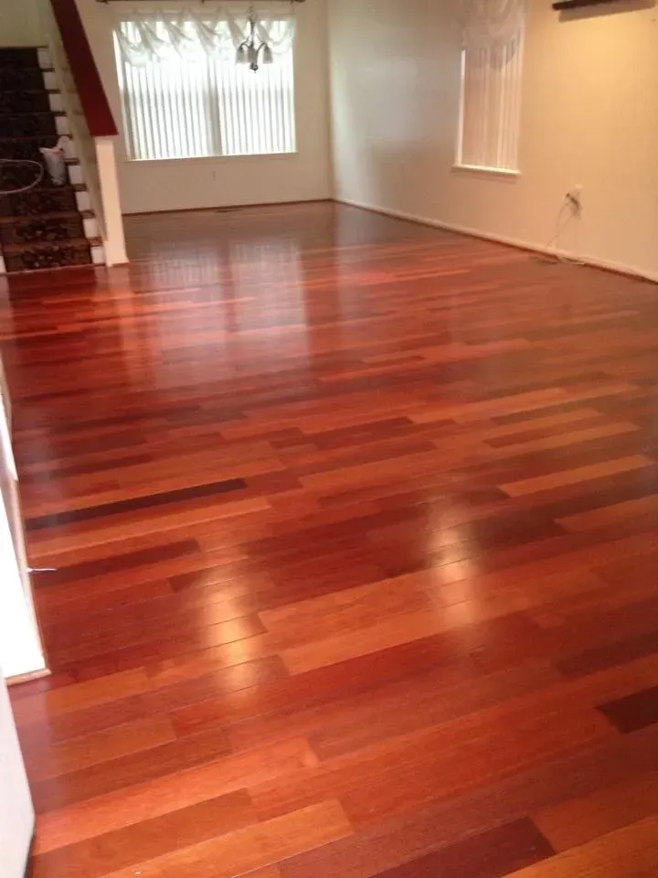 A living room with hardwood floors and stairs.